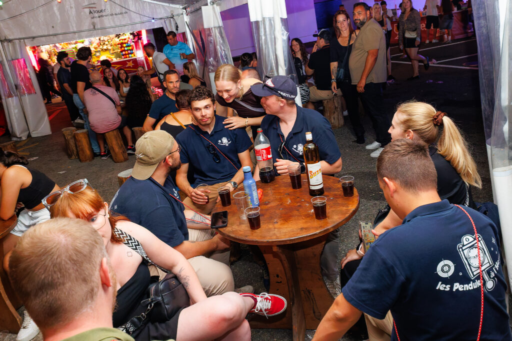 Groupe de personnes en polo bleu marine attablées lors d'une fête